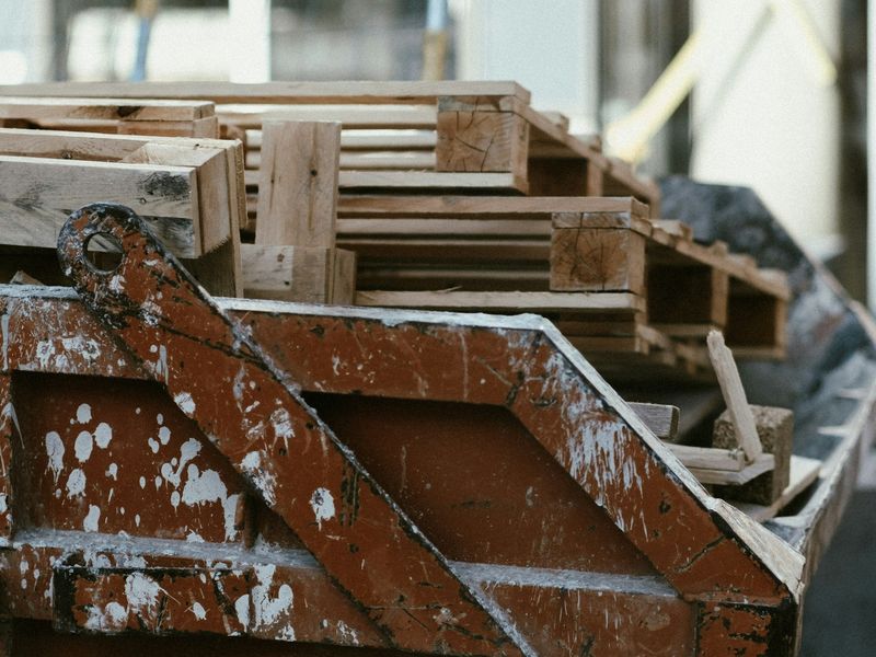 A large skip filled with pallets and commercial waste